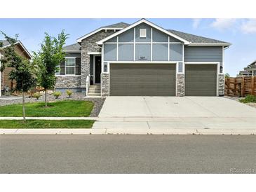 Charming two-story home featuring a three-car garage and stone accents at 5417 Riverbend Ave, Firestone, CO 80504