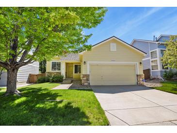 Charming single-Gathering home featuring a well-maintained lawn and attached two car garage at 9860 Burberry Way, Highlands Ranch, CO 80129