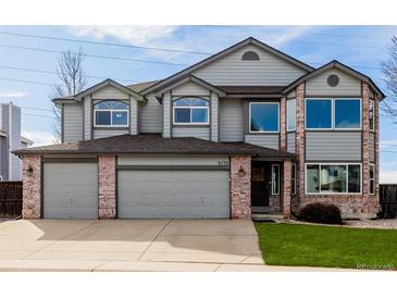 Charming two-story home with brick accents and a three-car garage at 9275 Erminedale Dr, Lone Tree, CO 80124