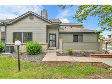 Charming townhome featuring a well-maintained lawn and stone accents at 9183 W Cedar Dr # 2, Lakewood, CO 80226