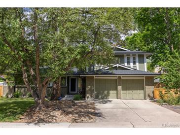 Charming exterior featuring a large front yard, and a two-car garage at 7150 S Curtice St, Littleton, CO 80120