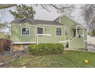 Charming green home with well-maintained landscaping and inviting entrance at 4162 S Richfield S Way, Aurora, CO 80013