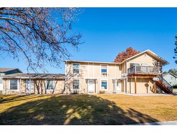 Charming exterior view of a two-story home with a well-maintained lawn on a sunny day at 2105 Coronado Pkwy # C, Denver, CO 80229