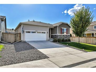 Charming single-Gathering home with a well-maintained front yard and a two-car garage in a suburban neighborhood at 27862 E 9Th Dr, Aurora, CO 80018