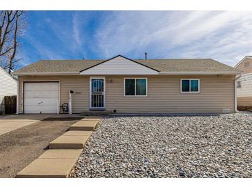 Charming single-story home featuring a gravel yard, and a one-car garage at 1882 S Stuart St, Denver, CO 80219
