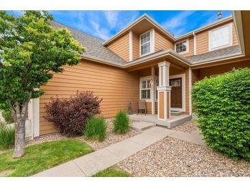 Charming home with a well-manicured lawn and inviting front porch, perfect for enjoying peaceful moments at 11705 W Stanford Ln, Morrison, CO 80465