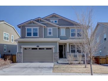 Two-story home boasts a neutral color scheme and attached two car garage at 8760 Ginkgo Loop, Parker, CO 80134