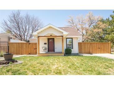 Charming single-story home featuring a welcoming front porch and well-maintained lawn at 851 Quitman St, Denver, CO 80204