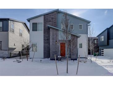 Two-story modern home with gray and white exterior, landscaping, and a paved walkway in winter at 23670 E 41St Ave, Aurora, CO 80019