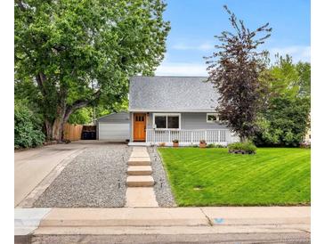 Charming gray home boasts a manicured lawn and inviting front porch, enhancing its curb appeal at 2535 S Julian St, Denver, CO 80219