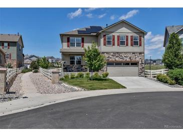 Charming two-story home featuring stone accents, a two-car garage, and manicured front yard at 5789 Echo Park Cir, Castle Rock, CO 80104