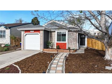 Charming single-Gathering home features a brick and gray exterior with a well-manicured front yard at 3071 S Truckee St, Aurora, CO 80013