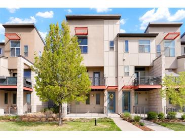 Contemporary townhome featuring balconies, patios, modern design elements, and well-maintained landscaping at 8953 E Northfield Blvd, Denver, CO 80238