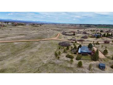 Expansive aerial view showcases the property's serene country setting and rolling landscape at 2130 Frontier Ln, Franktown, CO 80116