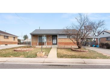 Charming brick home with a cozy front yard and covered entry at 7140 Avrum Dr, Denver, CO 80221