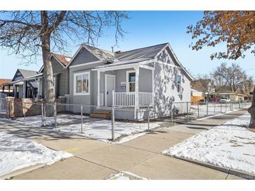 Gray house with a white porch and chain link fence, winter scene at 3500 N Marion St, Denver, CO 80205