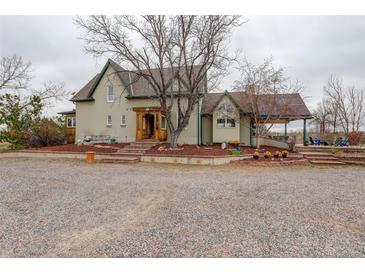 Charming home boasts unique architecture, beautiful landscaping, and an inviting gravel driveway at 13200 E 160Th Ave, Brighton, CO 80602