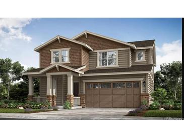 Charming two-story home with a covered porch, two-car garage, and meticulously landscaped front yard at 164 Baler Ct, Brighton, CO 80601
