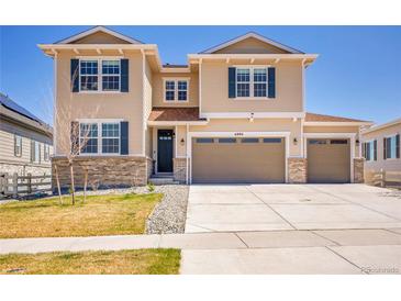 Inviting two-story home featuring neutral siding, a three-car garage, and a well-manicured front lawn at 6880 S Yantley Ct, Aurora, CO 80016