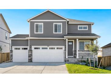 Two-story house with gray siding, white trim, and a two-car garage at 13432 Wabash St, Thornton, CO 80602