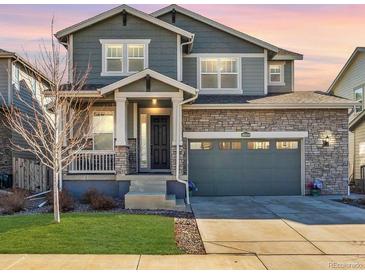 Charming two-story home with stone accents, well-maintained lawn, and attached two-car garage at 26304 E 4Th Pl, Aurora, CO 80018