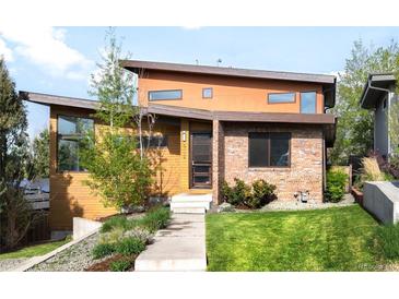 Contemporary home featuring a unique design with mixed materials and a well-manicured front yard and inviting front entrance at 5134 Quitman St, Denver, CO 80212