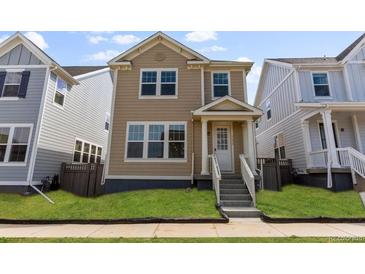 Charming two-story home with a well-manicured lawn and inviting front entrance and stairs at 245 Washington St, Erie, CO 80516