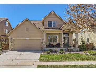 Charming two-story home featuring a well-manicured lawn, covered entryway and attached two-car garage at 11332 E 111Th Ave, Commerce City, CO 80640