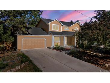 Inviting home featuring a spacious driveway and attached garage at 308 Oswego St, Aurora, CO 80010