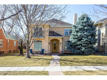 Charming stucco two-story home with a landscaped front yard and inviting front porch at 2411 S Milwaukee St, Denver, CO 80210