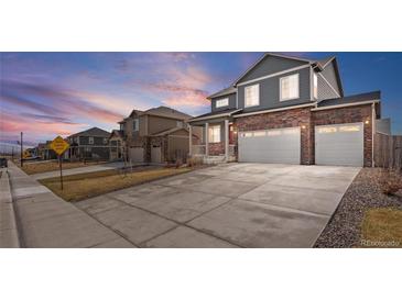 Beautiful two-story home with a brick facade and spacious three-car garage at 8388 E 132Nd Pl, Thornton, CO 80602