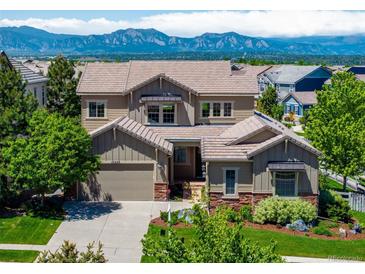 Charming two-story home featuring a well-manicured lawn and beautiful mountain views at 16069 Pikes Peak Dr, Broomfield, CO 80023