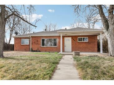 Charming red brick home with a well-manicured lawn and inviting walkway to the front door at 1540 E 95Th Ave, Thornton, CO 80229