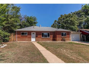 Charming red brick home with a well-maintained front yard and attached one car garage at 9150 Lilly Ct, Thornton, CO 80229