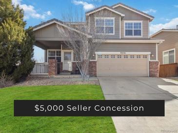 Charming two-story home featuring a two-car garage and inviting covered porch at 9378 Longstone Dr, Parker, CO 80134