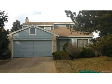 Two-story house with attached garage, landscaping, and a brick facade at 17969 E Brown Pl, Aurora, CO 80013