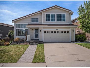 Charming two-story home featuring a well-manicured front yard and attached two car garage at 9195 Anasazi Indian Trl, Highlands Ranch, CO 80129