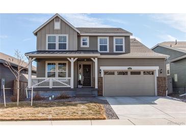 Charming two-story home with a covered porch, two-car garage, and well-maintained landscaping at 17046 Desert Wine Trl, Parker, CO 80134