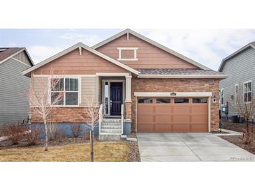 Charming single-Gathering home featuring a brick facade, two-car garage, and manicured lawn at 8844 S Sicily Ct, Aurora, CO 80016