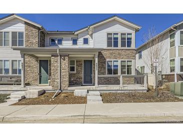 Charming two-story home featuring stone accents and a welcoming front porch at 8833 Meade St, Westminster, CO 80031