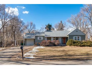 Charming single-story home with a well-manicured lawn and a cozy front porch at 1351 Reed St, Lakewood, CO 80214