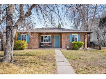 Charming brick home featuring a manicured front yard, blue shutters, and an inviting walkway at 2686 S Gilpin St, Denver, CO 80210