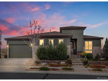 Charming home featuring a stone and siding facade, landscaped front yard, and attached two-car garage at 12431 Red Fox Way, Broomfield, CO 80021