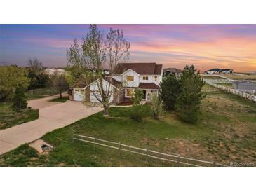 Beautiful two-story home with a three car garage, lush lawn and a large front yard at 28700 E 160Th Pl, Brighton, CO 80603