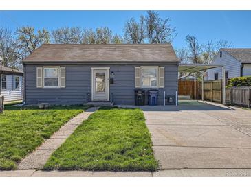 Charming single-story home features a well-maintained front yard and convenient driveway with carport at 2080 S King St, Denver, CO 80219