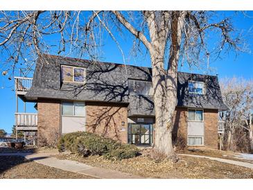 Brick building exterior with mature trees and landscaping at 309 E Highline Cir # 103, Centennial, CO 80122