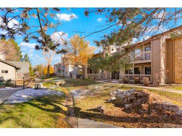 Exterior view of condo building, showing landscaping and walkway at 10273 E Peakview Ave # D202, Englewood, CO 80111