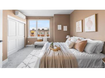 Bright bedroom featuring a large window, bench, and neutral decor that creates a soothing atmosphere at 1305 Osceola St, Denver, CO 80204