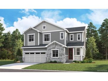 Two-story house with gray siding, stone accents, and a three-car garage at 1131 Joseph Pl, Erie, CO 80026