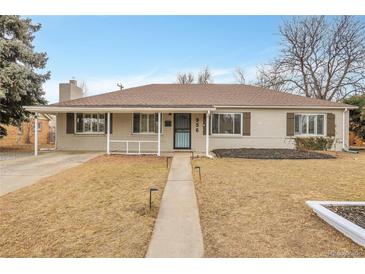 Charming single-story home with a covered porch and well-maintained lawn at 956 Racine St, Aurora, CO 80011